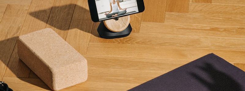 Yoga blocks and a rolled mat on floor.